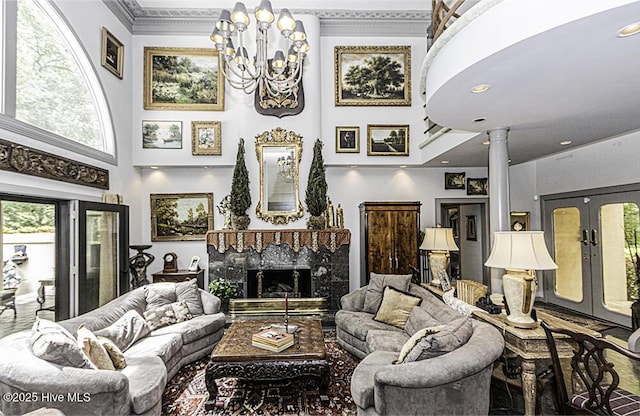 129 Steeplechase Rd, Rocky Mount, NC 27804 - living room with a high ceiling, a chandelier, ornamental molding, a high end fireplace, and decorative columns