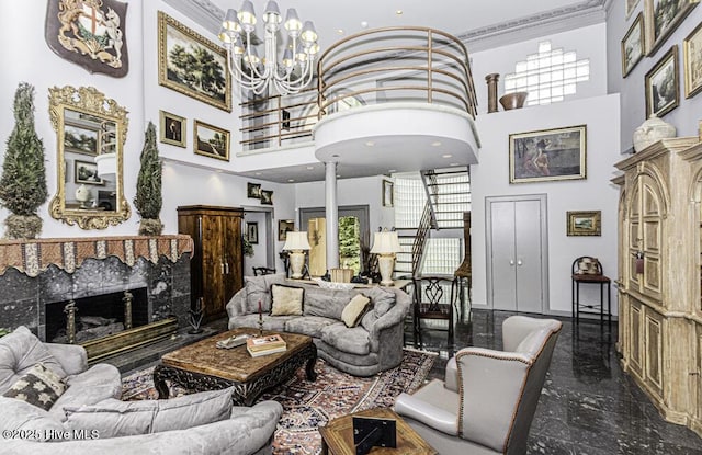 129 Steeplechase Rd, Rocky Mount, NC 27804 - living room with a high ceiling, a chandelier, a high end fireplace, ornamental molding, and decorative columns