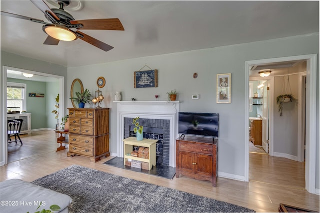 766 Swan Point Rd, Washington, NC 27889 - living area with wood finished floors, a ceiling fan, and a tile fireplace