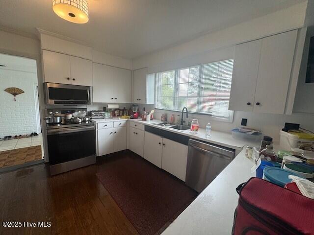 621 W Hayes St, Ahoskie, NC 27910 - kitchen with stainless steel appliances, dark wood finished floors, light countertops, and white cabinets