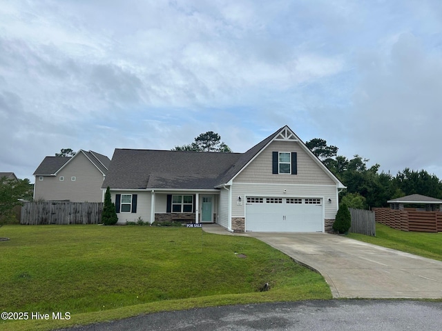 207 Misty Cove Ct, Sneads Ferry, NC 28460 - view of front of home featuring stone siding, driveway, and a garage