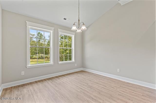 414 Laurel Ct NW, Calabash, NC 28467 - unfurnished room with a chandelier, light wood finished floors, and lofted ceiling