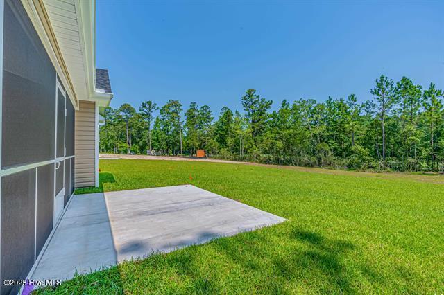 414 Laurel Ct NW, Calabash, NC 28467 - view of green lawn with a patio