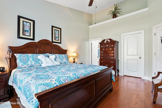 1067 Tideline Dr, Leland, NC 28451 - bedroom featuring dark wood-style flooring, a towering ceiling, and a ceiling fan