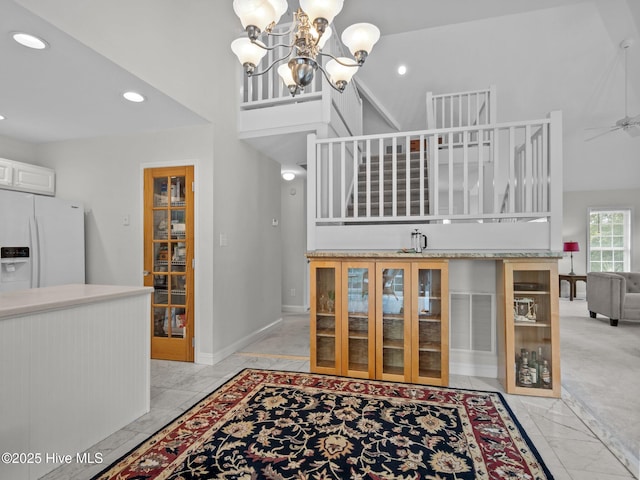 403 Emerald Landing Dr, Emerald Isle, NC 28594 - interior space with marble look tiles, recessed lighting, a chandelier, ceiling fan, and a high ceiling