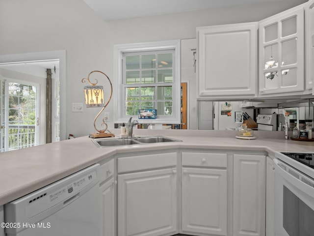403 Emerald Landing Dr, Emerald Isle, NC 28594 - kitchen with white appliances, white cabinetry, light countertops, and glass insert cabinets