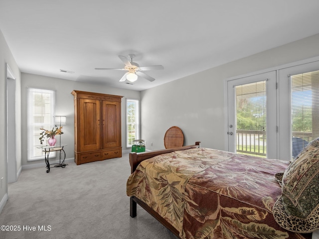 403 Emerald Landing Dr, Emerald Isle, NC 28594 - bedroom featuring access to exterior, multiple windows, and light carpet