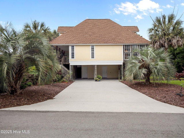 403 Emerald Landing Dr, Emerald Isle, NC 28594 - beach home with a carport, concrete driveway, and stairs