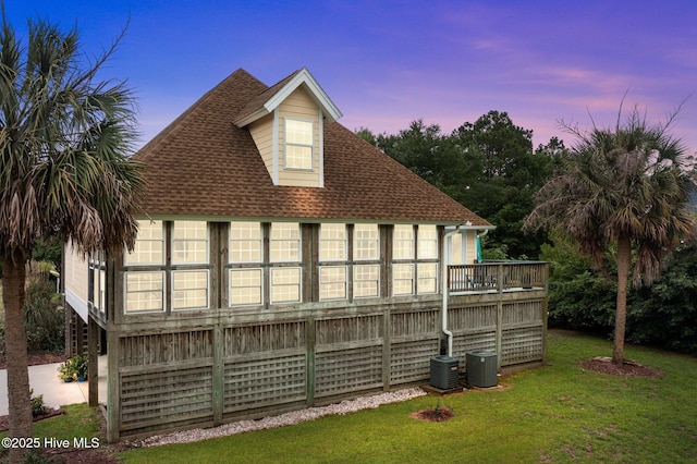 403 Emerald Landing Dr, Emerald Isle, NC 28594 - back of house at dusk featuring a yard and roof with shingles