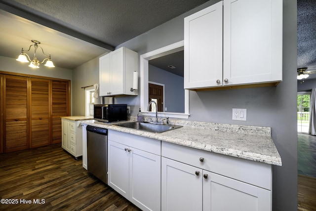 103 Elizabeth St, Havelock, NC 28532 - kitchen featuring stainless steel dishwasher, dark wood finished floors, white cabinetry, a chandelier, and a textured ceiling