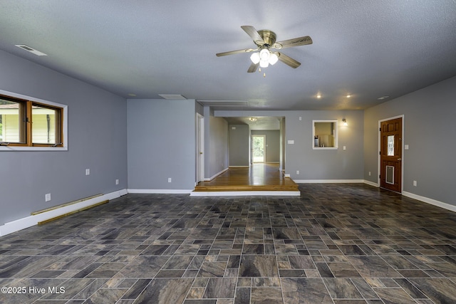 103 Elizabeth St, Havelock, NC 28532 - unfurnished living room with healthy amount of natural light, ceiling fan, a textured ceiling, and a baseboard radiator