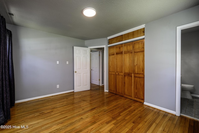 103 Elizabeth St, Havelock, NC 28532 - unfurnished bedroom with wood finished floors, a closet, and ensuite bathroom