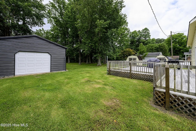 103 Elizabeth St, Havelock, NC 28532 - view of green lawn with an outdoor structure, a deck, and a garage