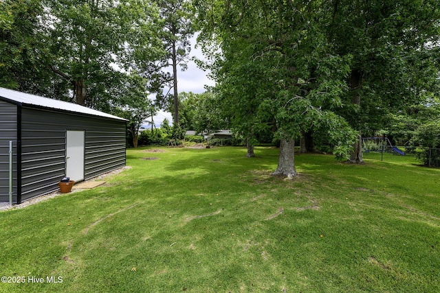 103 Elizabeth St, Havelock, NC 28532 - view of green lawn with an outdoor structure and a playground