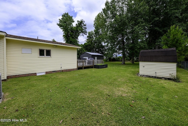 103 Elizabeth St, Havelock, NC 28532 - view of green lawn with a storage shed and a deck