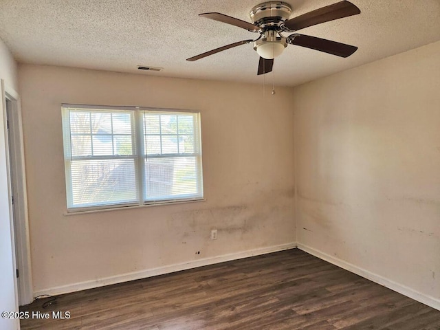 2823 Harvest, Grimesland, NC 27837 - empty room with dark wood finished floors, a textured ceiling, and a ceiling fan