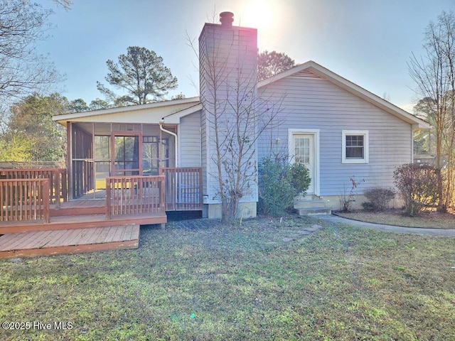 2823 Harvest, Grimesland, NC 27837 - back of property with a sunroom, a chimney, a lawn, and a deck