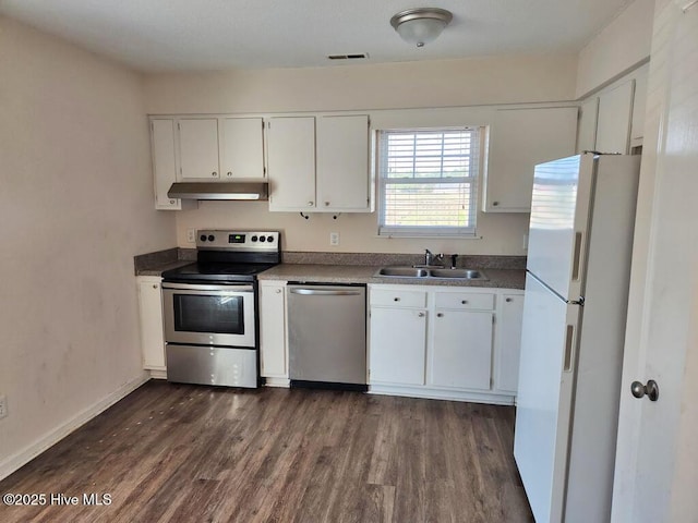 2823 Harvest, Grimesland, NC 27837 - kitchen featuring stainless steel appliances, under cabinet range hood, dark wood finished floors, and white cabinetry
