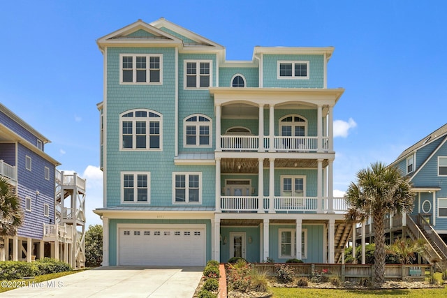 4101 Ocean Dr, Emerald Isle, NC 28594 - beach home with a balcony, an attached garage, concrete driveway, and a porch