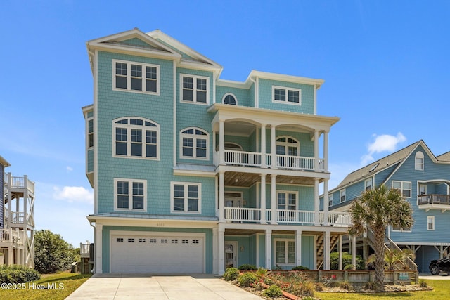 4101 Ocean Dr, Emerald Isle, NC 28594 - coastal home with a balcony, concrete driveway, and an attached garage