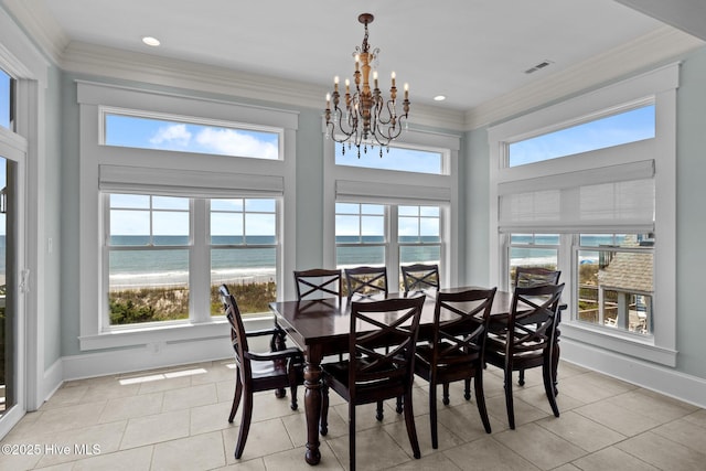 4101 Ocean Dr, Emerald Isle, NC 28594 - dining area featuring light tile patterned flooring, a chandelier, plenty of natural light, crown molding, and a water view