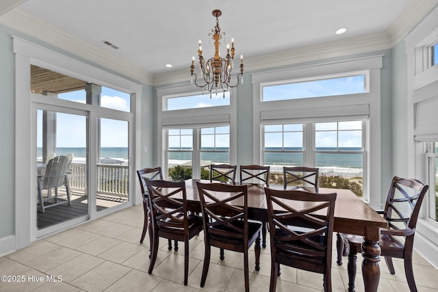4101 Ocean Dr, Emerald Isle, NC 28594 - dining space featuring a water view, a chandelier, light tile patterned floors, and ornamental molding