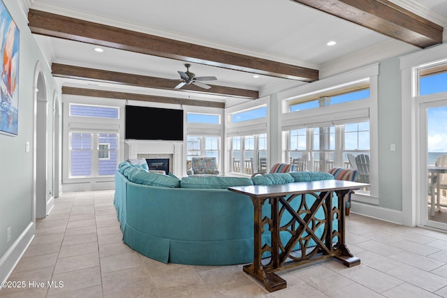 4101 Ocean Dr, Emerald Isle, NC 28594 - living room featuring beamed ceiling, ceiling fan, light tile patterned floors, a glass covered fireplace, and ornamental molding