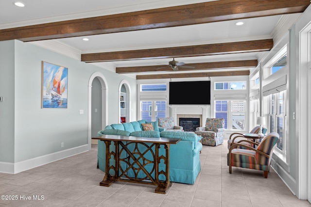 4101 Ocean Dr, Emerald Isle, NC 28594 - living room with ceiling fan, arched walkways, beamed ceiling, plenty of natural light, and a glass covered fireplace