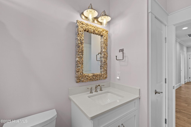 4101 Ocean Dr, Emerald Isle, NC 28594 - bathroom with vanity, ornamental molding, and wood finished floors