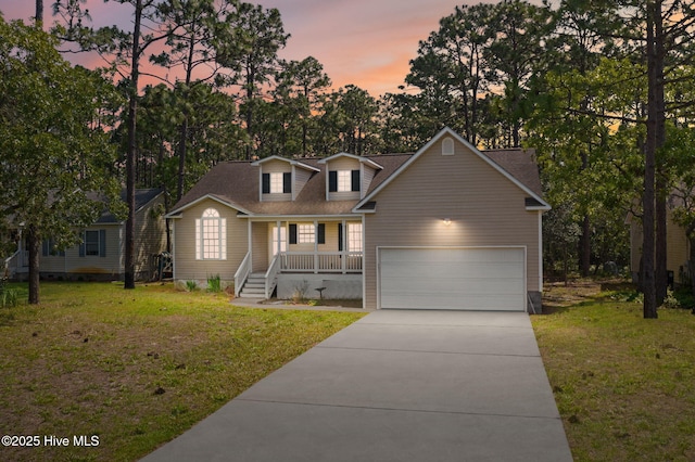 1281 Washington Rd, Southport, NC 28461 - view of front facade with a porch, concrete driveway, a front lawn, and an attached garage