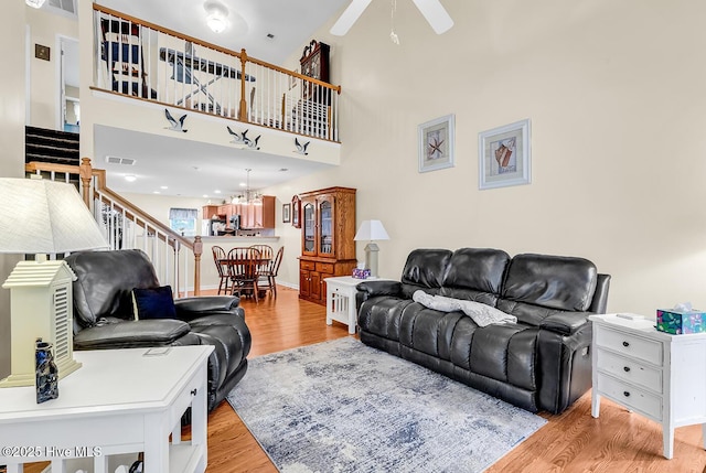 2129 Cass Lake Dr, Calabash, NC 28467 - living area with wood finished floors, ceiling fan, stairway, and a chandelier