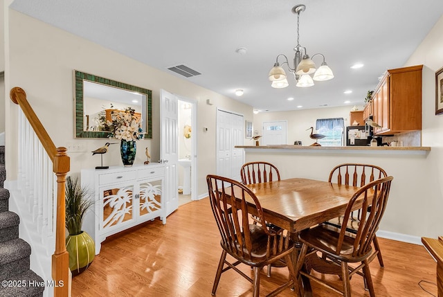 2129 Cass Lake Dr, Calabash, NC 28467 - dining space with a chandelier, stairs, light wood-type flooring, and recessed lighting