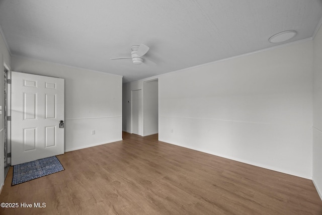 2402 S Lakeview Dr, Newport, NC 28570 - unfurnished bedroom with wood finished floors, crown molding, ceiling fan, and a closet