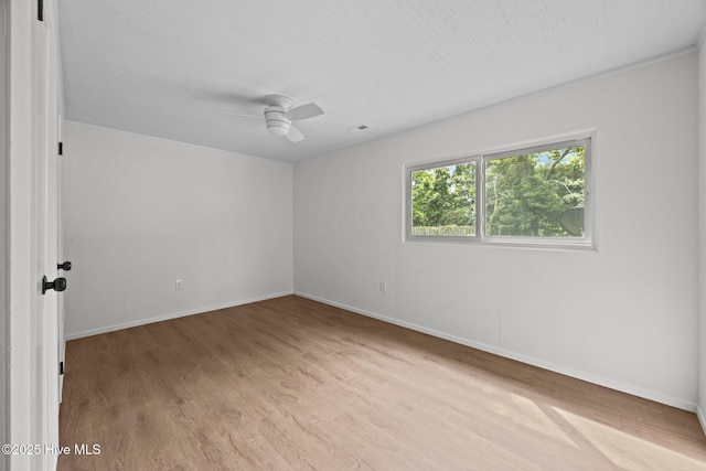 2402 S Lakeview Dr, Newport, NC 28570 - empty room with wood finished floors and a ceiling fan