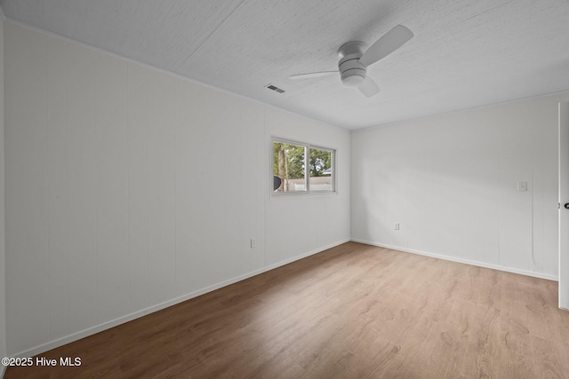 2402 S Lakeview Dr, Newport, NC 28570 - spare room with wood finished floors, a ceiling fan, and a textured ceiling