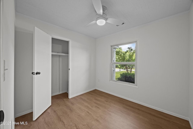 2402 S Lakeview Dr, Newport, NC 28570 - unfurnished bedroom featuring crown molding, light wood-style floors, a closet, and ceiling fan