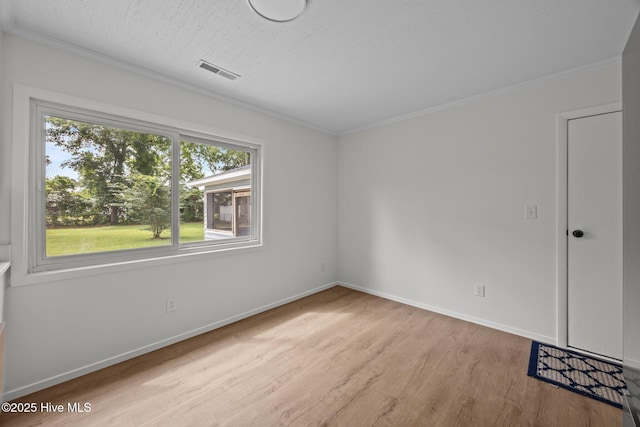 2402 S Lakeview Dr, Newport, NC 28570 - spare room with wood finished floors, crown molding, and a textured ceiling