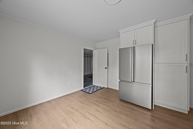2402 S Lakeview Dr, Newport, NC 28570 - unfurnished bedroom with freestanding refrigerator, wood finished floors, crown molding, and a closet