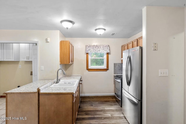 78 Clifford Rd, Red Springs, NC 28377 - kitchen featuring stainless steel appliances, light countertops, dark wood-style flooring, and brown cabinetry