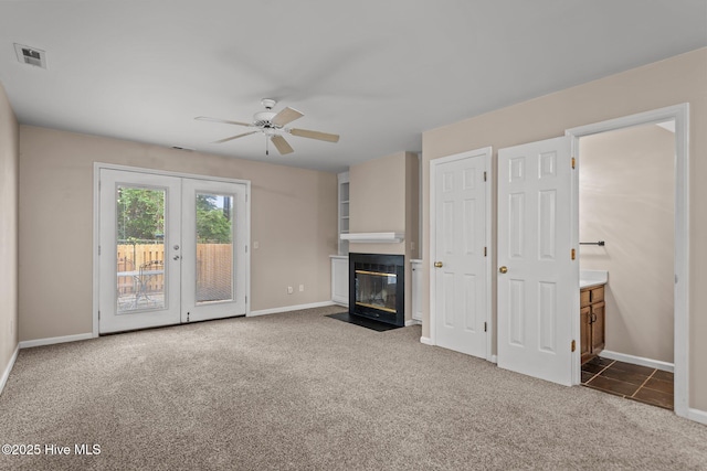 136 Lullwater Dr Unit B, Wilmington, NC 28403 - unfurnished living room with carpet, ceiling fan, a fireplace with flush hearth, and french doors