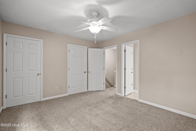 136 Lullwater Dr Unit B, Wilmington, NC 28403 - unfurnished bedroom featuring carpet, a textured ceiling, and a ceiling fan
