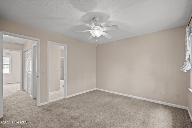 136 Lullwater Dr Unit B, Wilmington, NC 28403 - unfurnished bedroom with carpet floors, a textured ceiling, ceiling fan, and ensuite bathroom