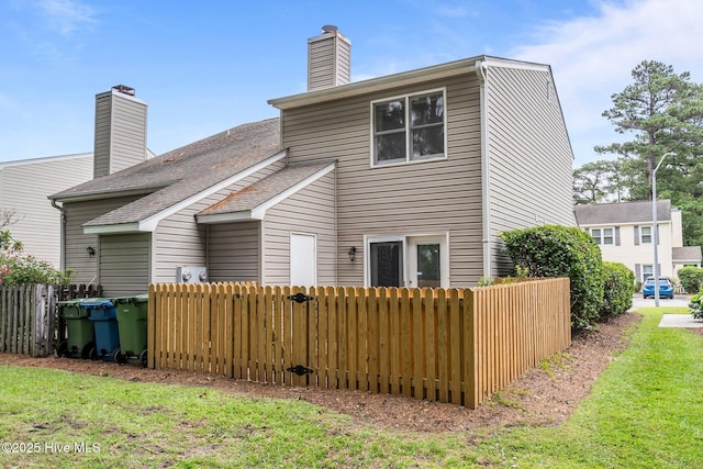 136 Lullwater Dr Unit B, Wilmington, NC 28403 - rear view of house with a chimney