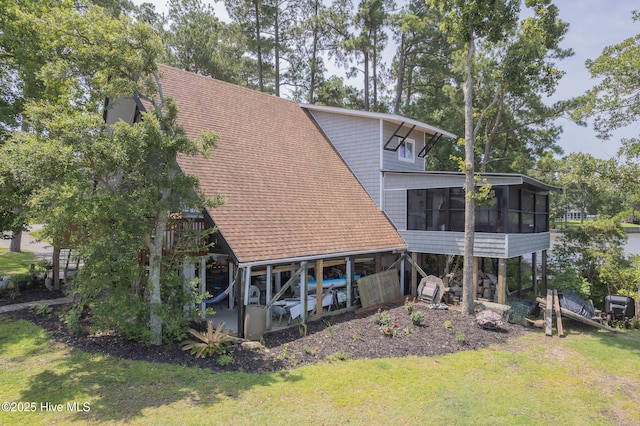 211 Fannie Creek Ln, Sneads Ferry, NC 28460 - rear view of property with a sunroom, a yard, and roof with shingles