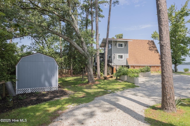 211 Fannie Creek Ln, Sneads Ferry, NC 28460 - view of grassy yard featuring a storage shed, gravel driveway, and stairs