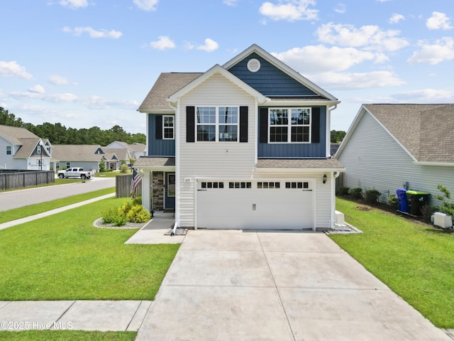 634 Aurora Pl, Hampstead, NC 28443 - view of front facade featuring board and batten siding, an attached garage, a front lawn, and concrete driveway