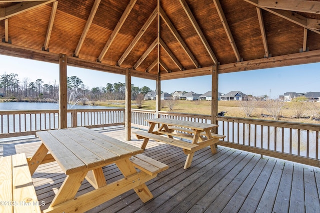 634 Aurora Pl, Hampstead, NC 28443 - wooden terrace with outdoor dining area, a water view, and a residential view