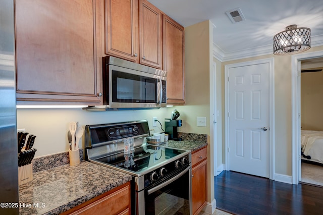 203 Sky Sail Blvd, New Bern, NC 28560 - kitchen featuring stainless steel appliances, brown cabinets, dark wood finished floors, dark stone countertops, and ornamental molding