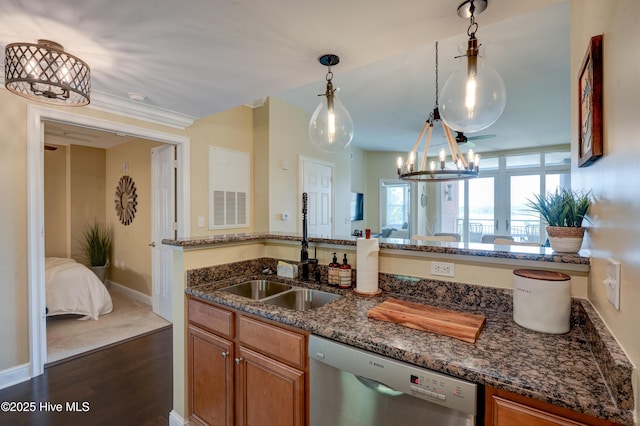 203 Sky Sail Blvd, New Bern, NC 28560 - kitchen featuring stainless steel dishwasher, dark wood-type flooring, brown cabinets, and a chandelier