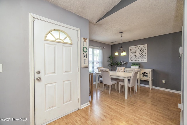 2505 Legend Dr, Wilmington, NC 28405 - dining room featuring a textured ceiling and light wood finished floors